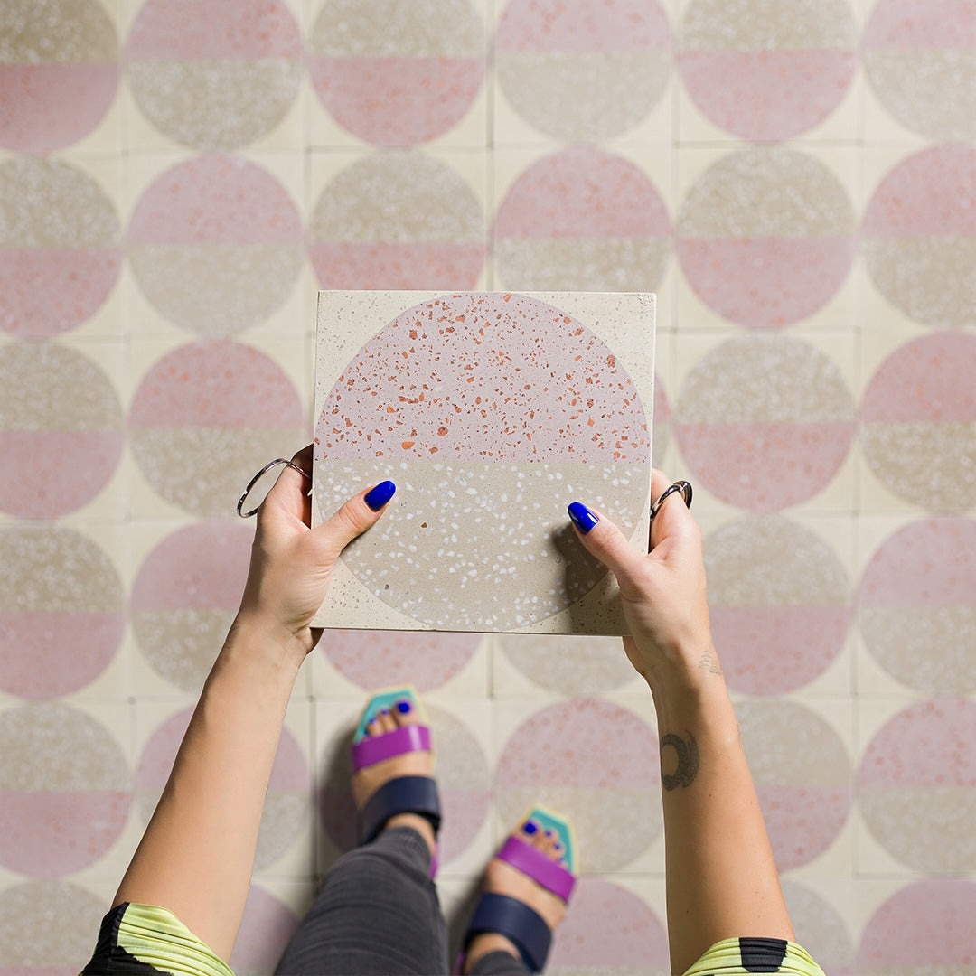 Square tile with terrazzo pattern featuring two concentric circles on a white background.