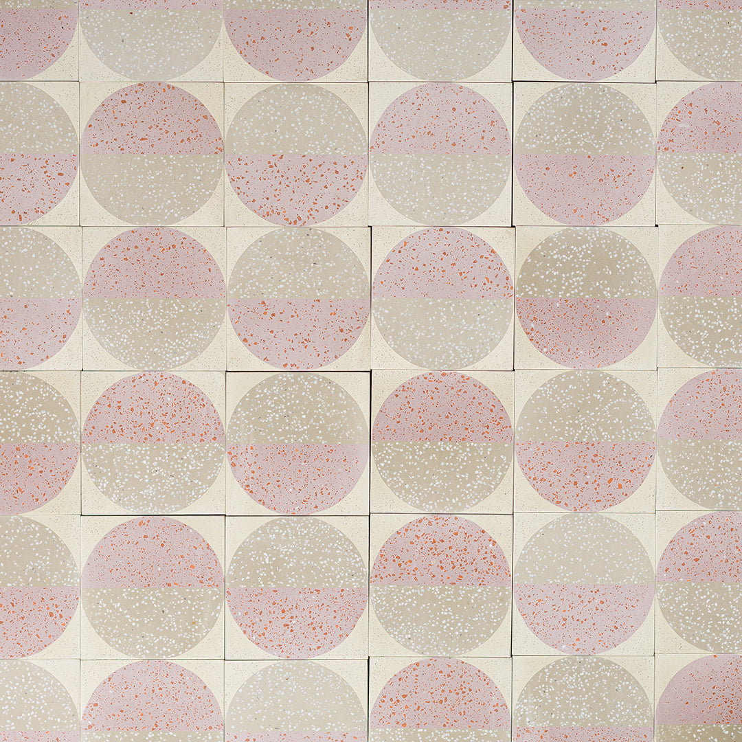 Square tile with terrazzo pattern featuring two concentric circles on a white background.