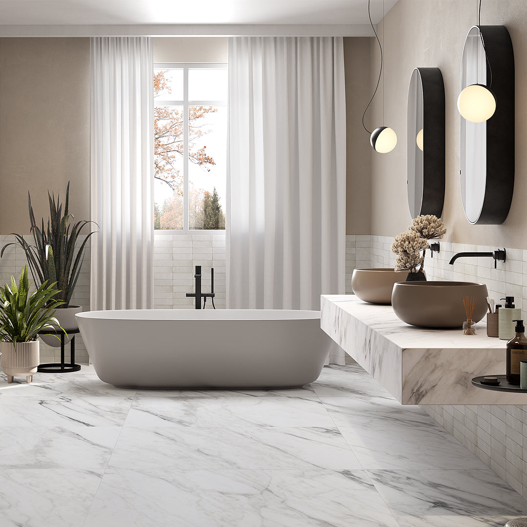 Modern bathroom with freestanding bathtub, marble floor, and decorative elements.