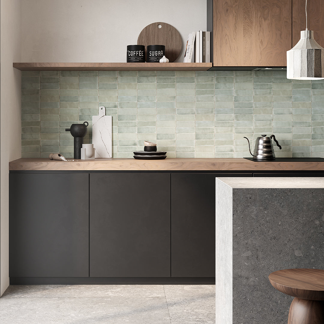 Modern kitchen with wooden countertops, gray cabinets, and a tiled backsplash.