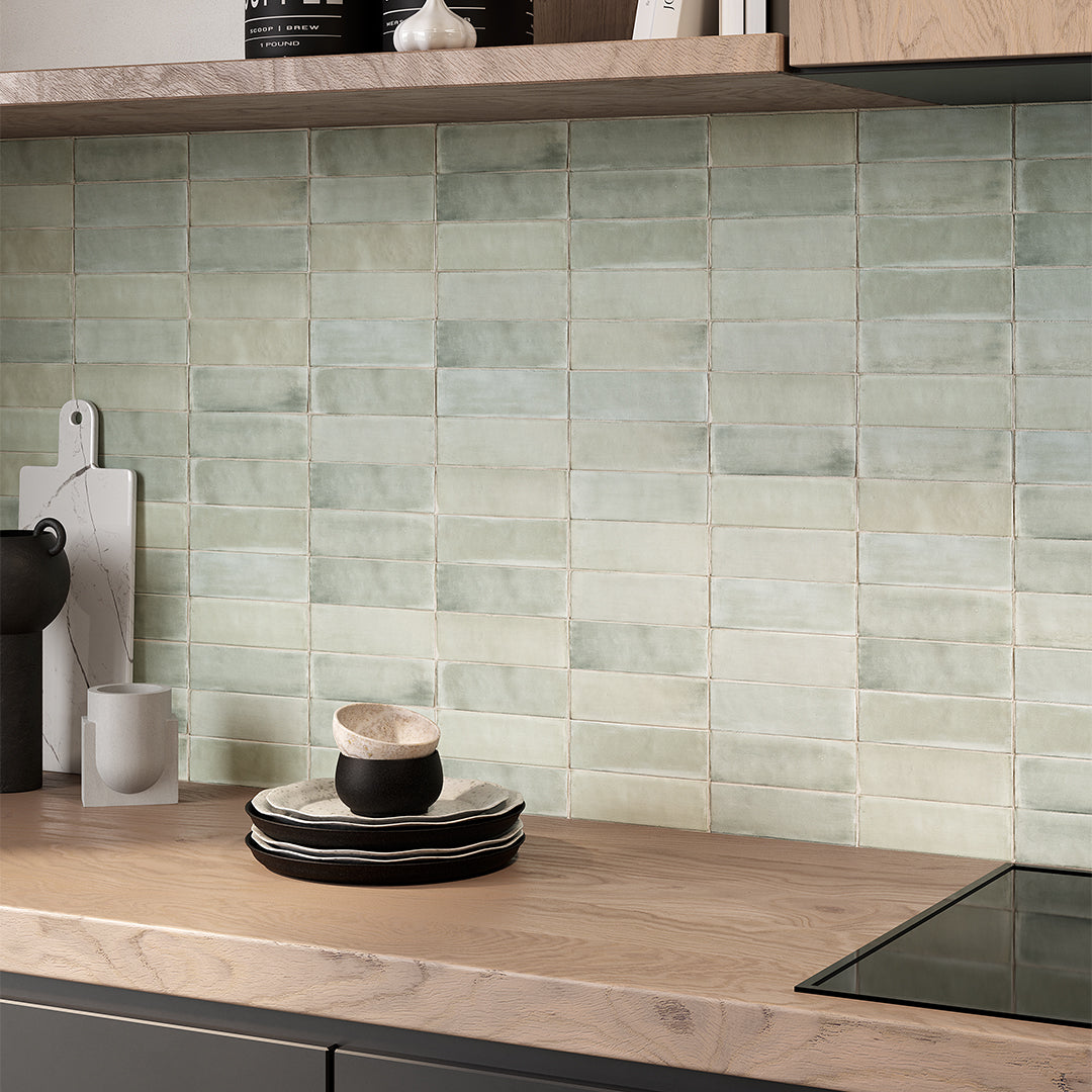 Kitchen with wooden countertop and green tiled backsplash