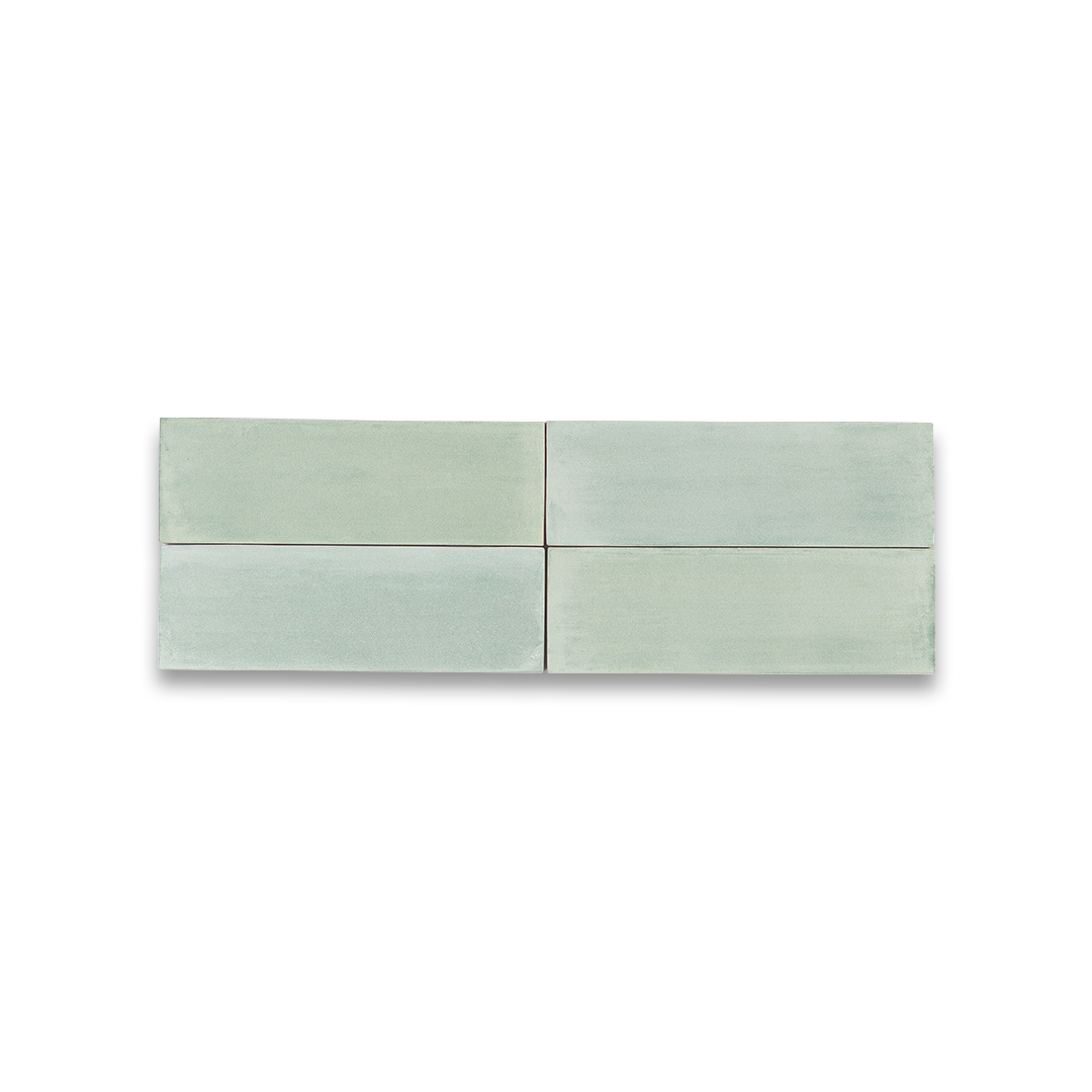 Two light green ceramic tiles on a white background