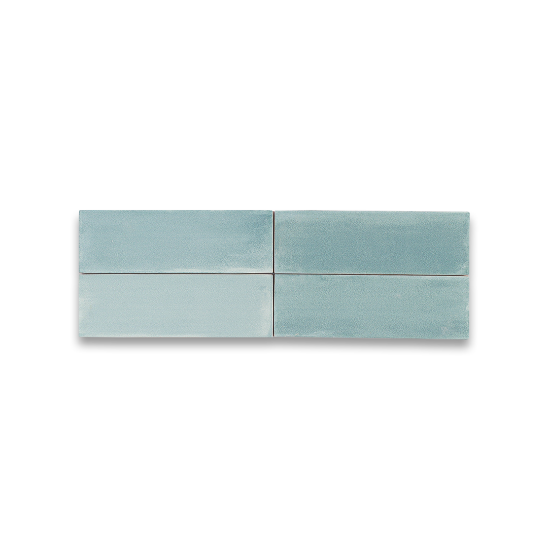 Four light blue ceramic tiles on a white background