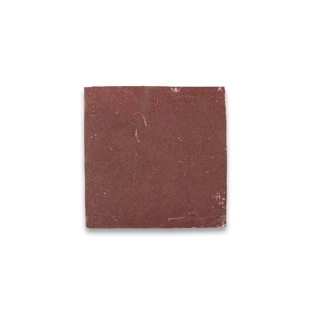 Square piece of sandpaper with a red-brown color on a white background