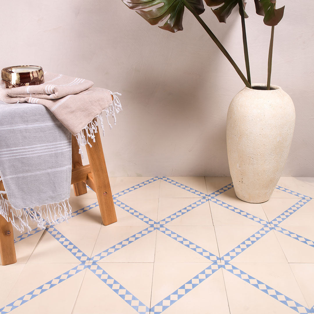 Cement tile featuring a white base with a diagonal blue-and-white checkered stripe, perfect for Mediterranean interiors, accent walls, or patterned floor layouts.