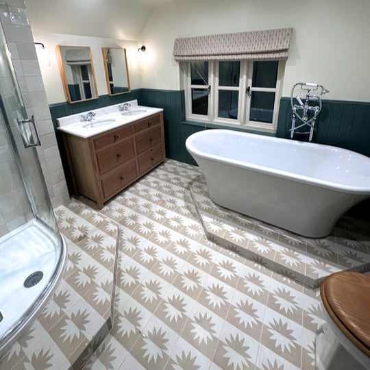 Beige and ivory cement tile featuring a mirrored floral sunburst motif, ideal for modern interiors, decorative wall panels, or contemporary geometric floor pattern designs.