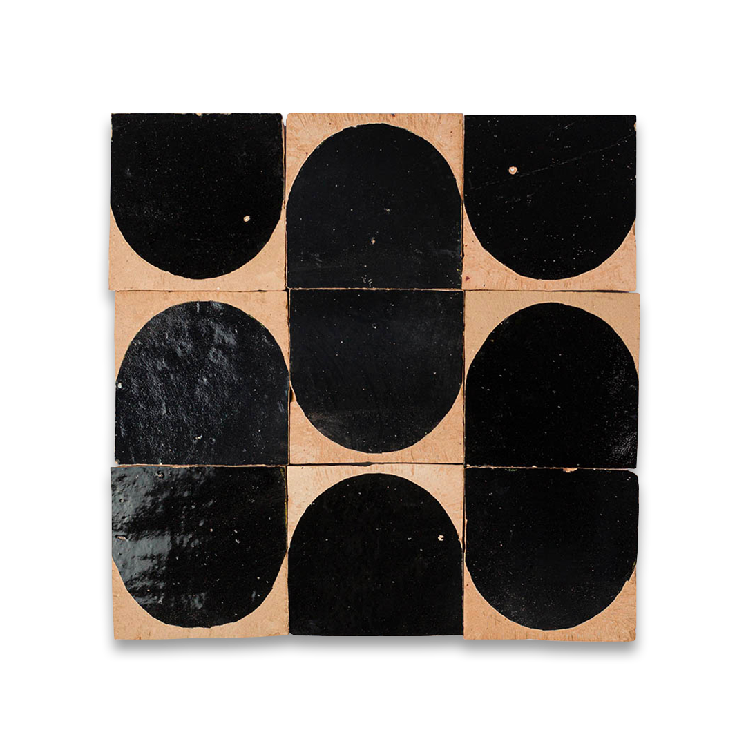 Set of black oval tiles on a beige background