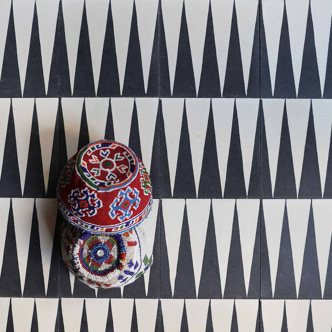 A bold black and white triangular geometric pattern with a matte finish, square shape, ideal for modern, minimalist, or contemporary flooring and wall décor applications.