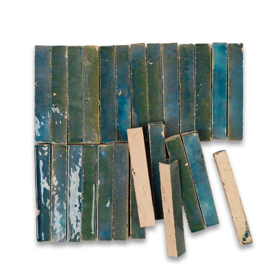 Collection of green and blue ceramic tiles on a white background