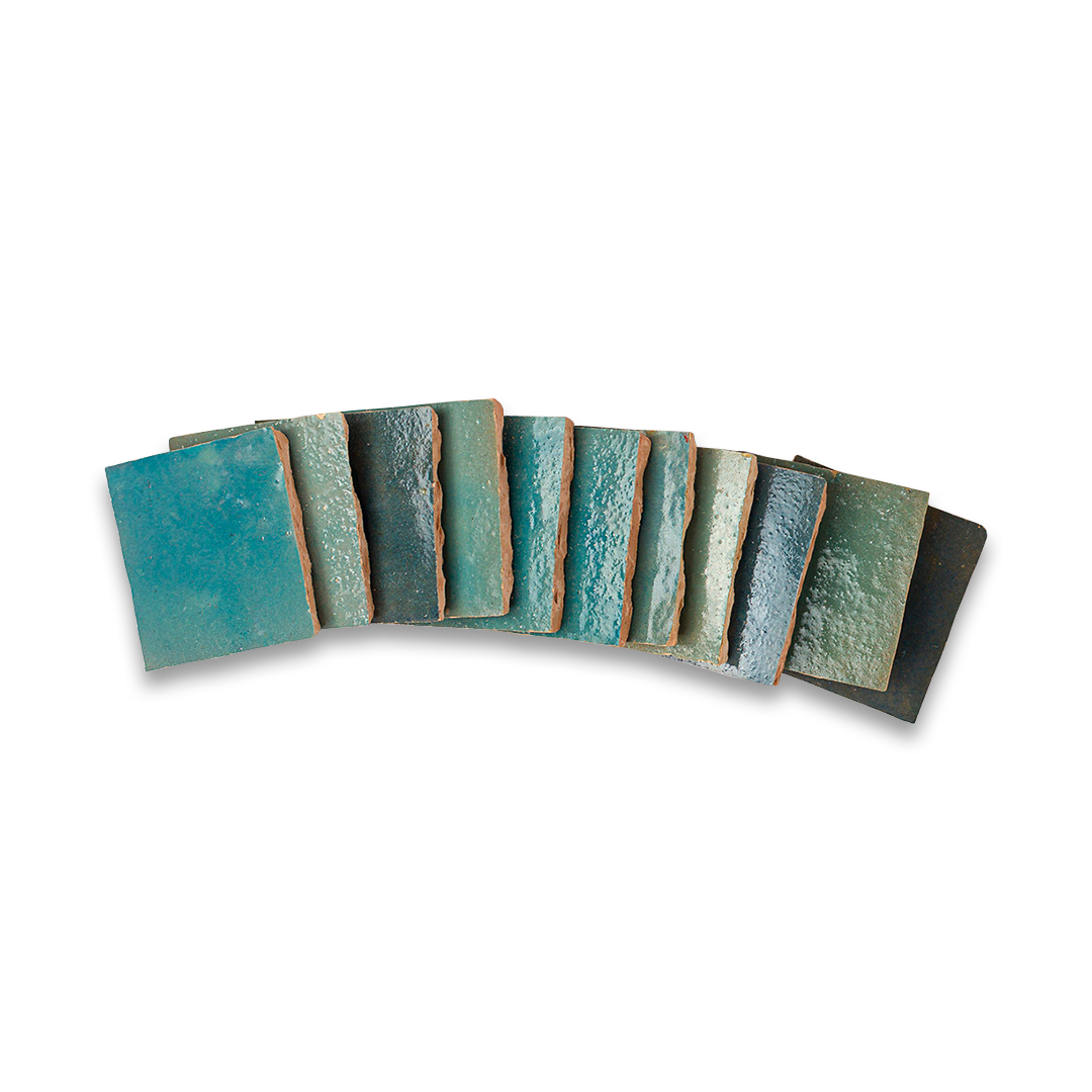 Set of ceramic coasters with teal and brown glaze on a white background