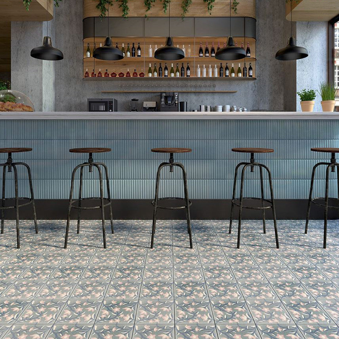 Cement tile featuring a floral pattern with pink and white blossoms on dark teal vines over a soft gray background, matte finish, ideal for vintage, bohemian, or Mediterranean interiors.