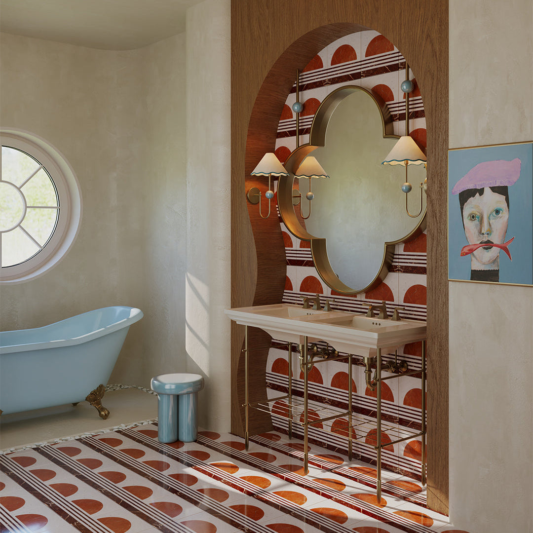 Bathroom with a freestanding bathtub, patterned tiles, and decorative mirror.