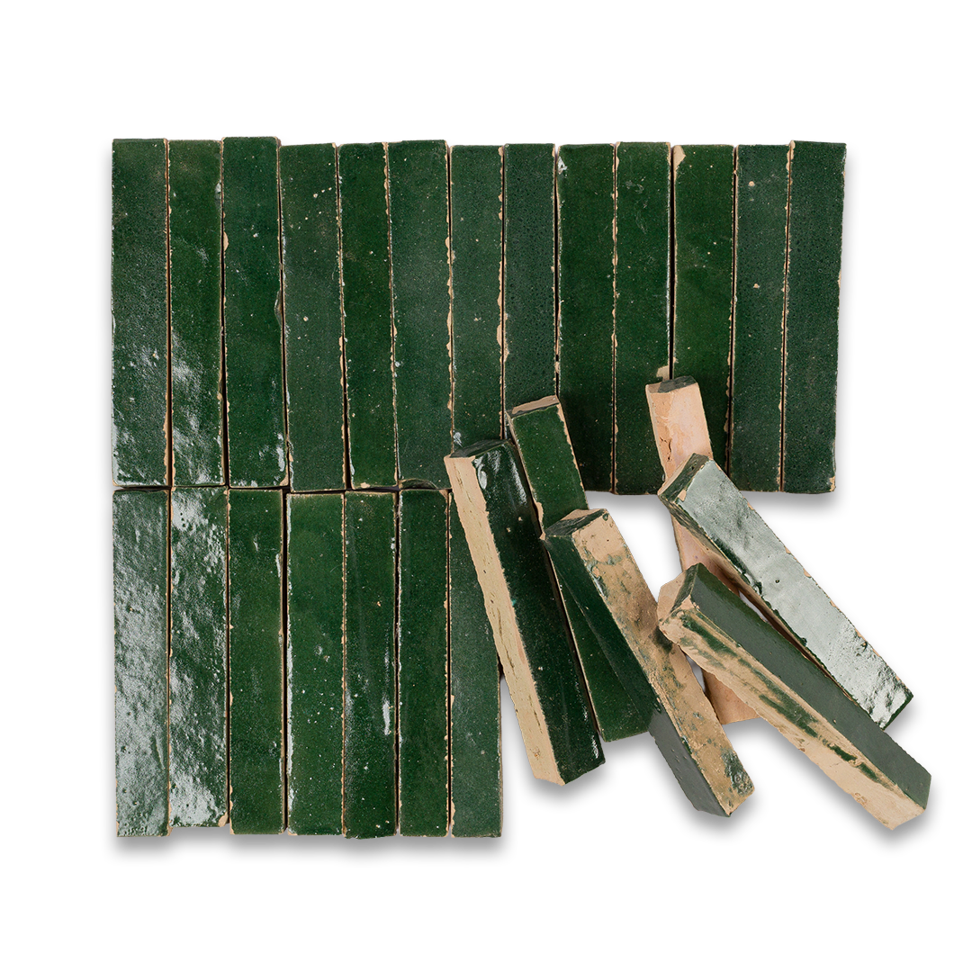 Green ceramic tiles with chipped paint on a white background