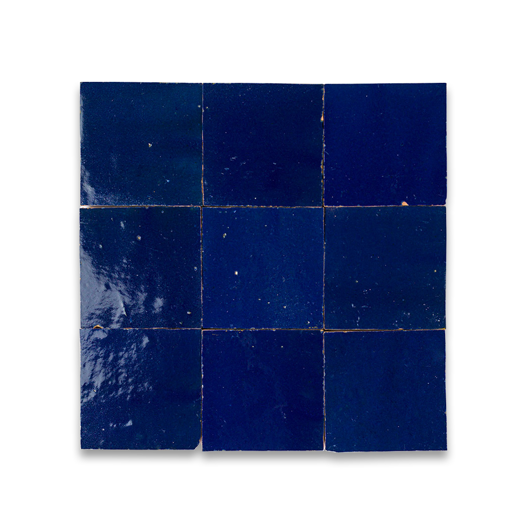 Nine glossy deep blue bathroom tiles in grid arrangement, showing subtle texture variations, imperfections, and grout lines.