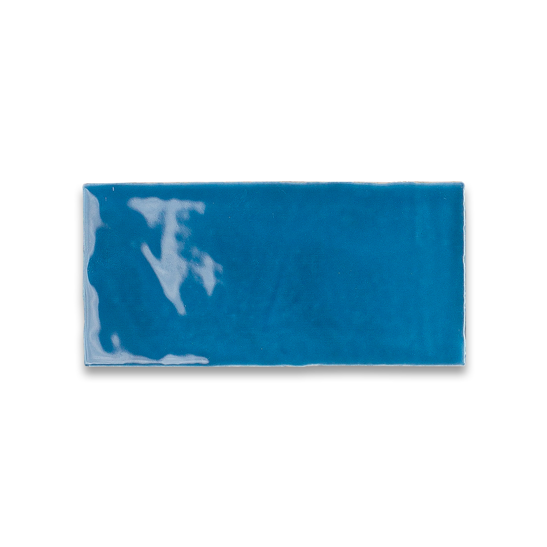 Blue rectangular tile with a white anchor design on a white background
