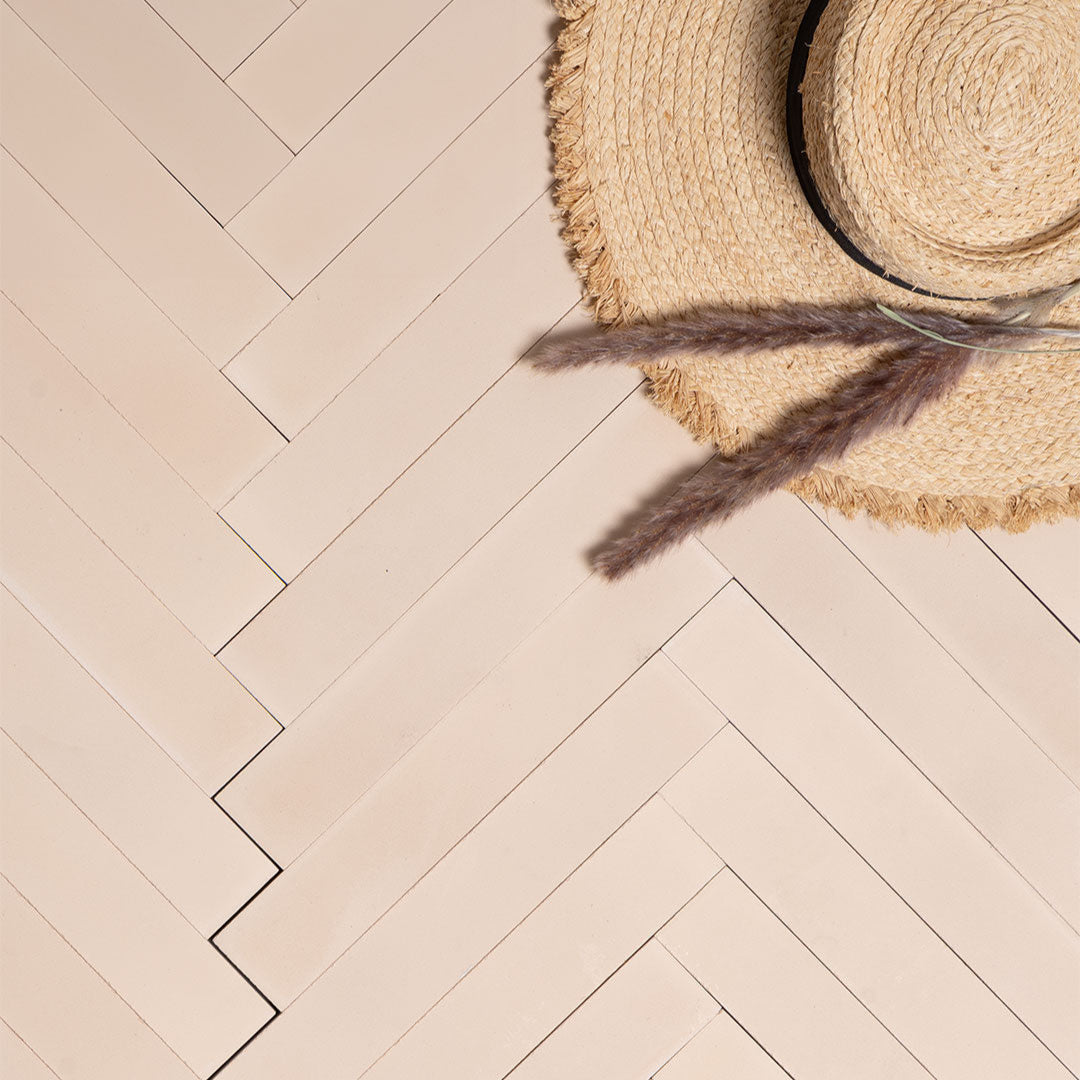 Egg Shell Herringbone cement tile arrangement featuring elongated rectangular tiles in a soft beige tone, smooth matte finish, minimalist modern design ideal for contemporary flooring, wall cladding, and interior décor applications.