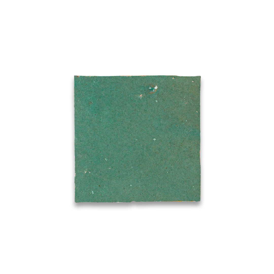Green square tile with speckled texture on a white background