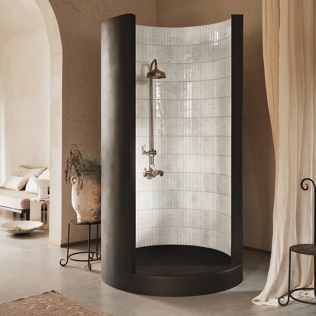 Modern shower enclosure with tiled wall in a bathroom setting