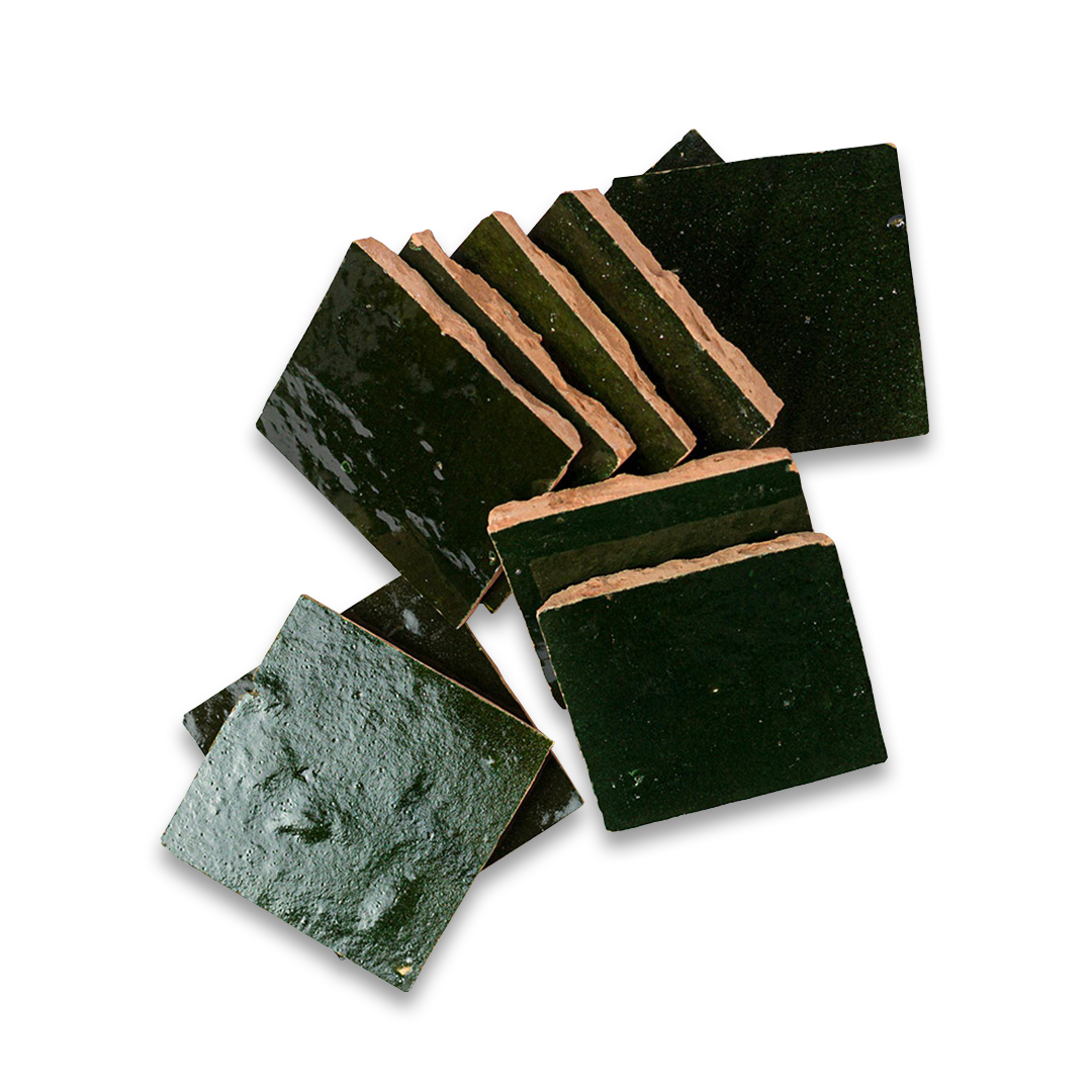 Set of dark green stone coasters with brown rubber pads on a white background