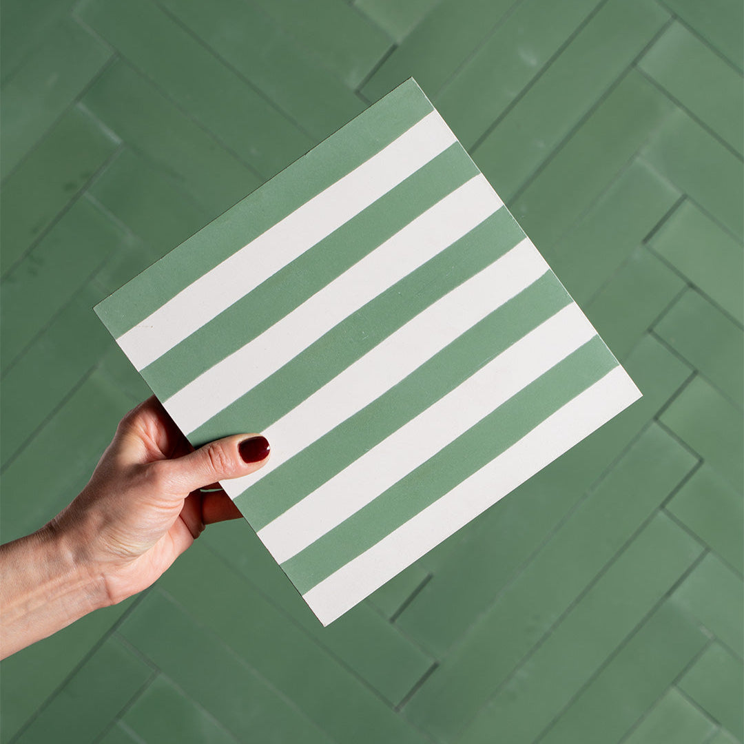 An alternating vertical green and white stripes with a matte finish, ideal for modern, retro, or Mediterranean interior flooring, wall décor, and accent design applications.