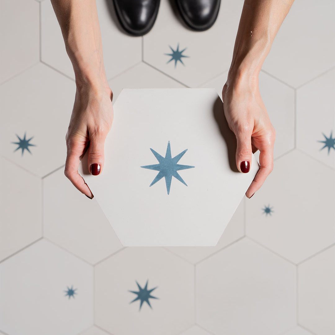 A decorative patterned tile featuring a geometric blue star design, ideal for enhancing modern interiors, walls, and contemporary architectural spaces.