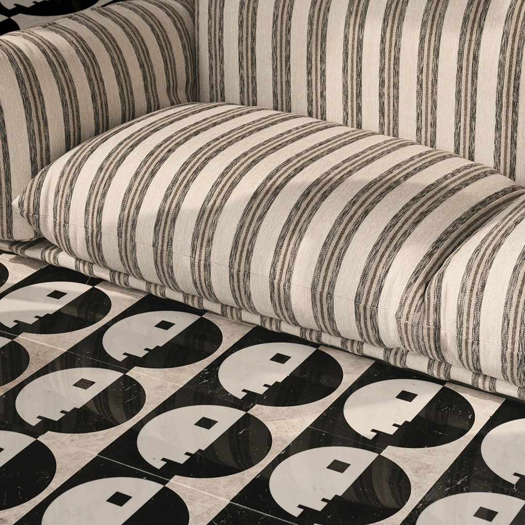 Striped fabric with a pattern of black and white shapes on a checkered background