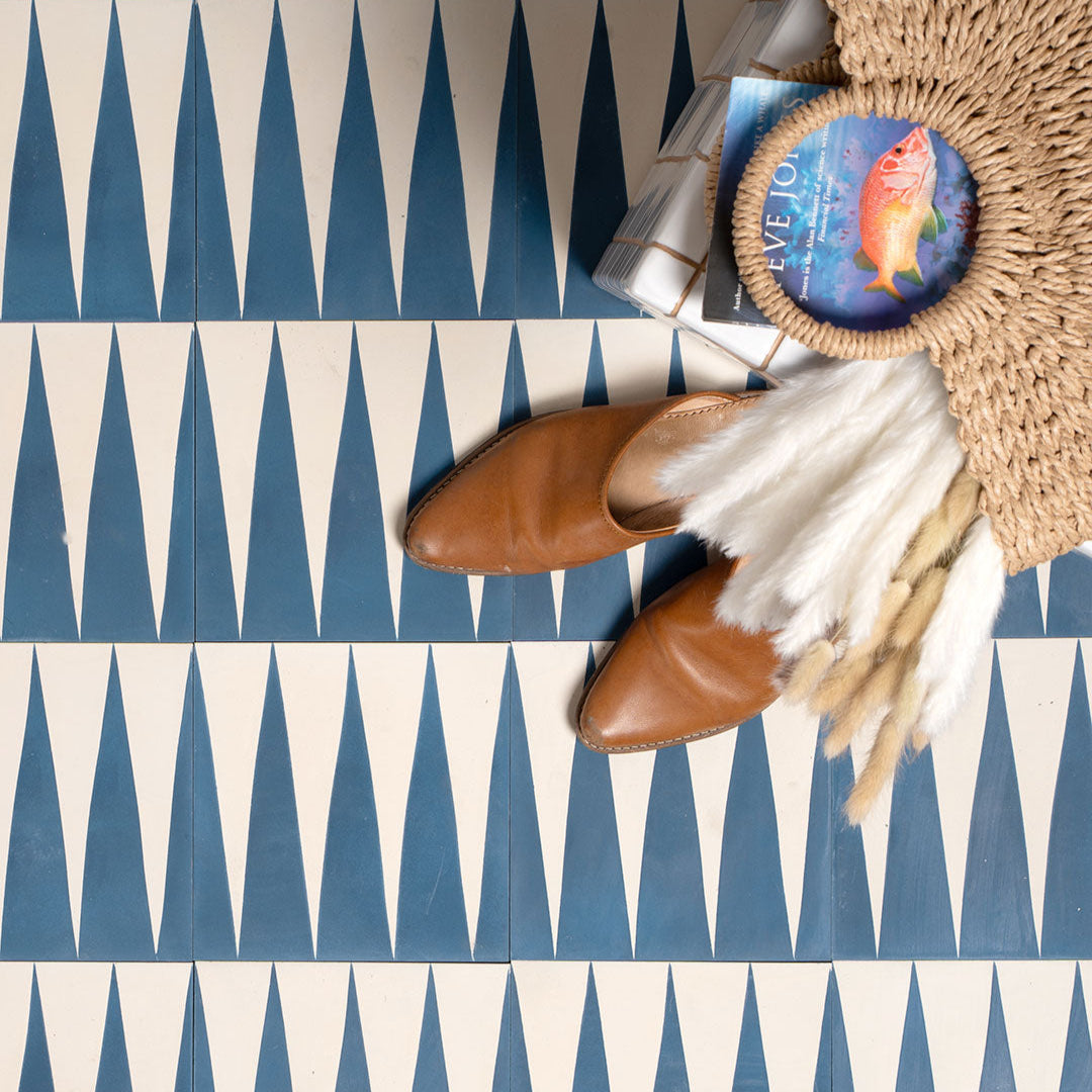 Cement tile featuring alternating deep teal blue and white elongated triangular patterns, matte finish, ideal for modern, geometric, or Mediterranean interior flooring and wall décor applications.
