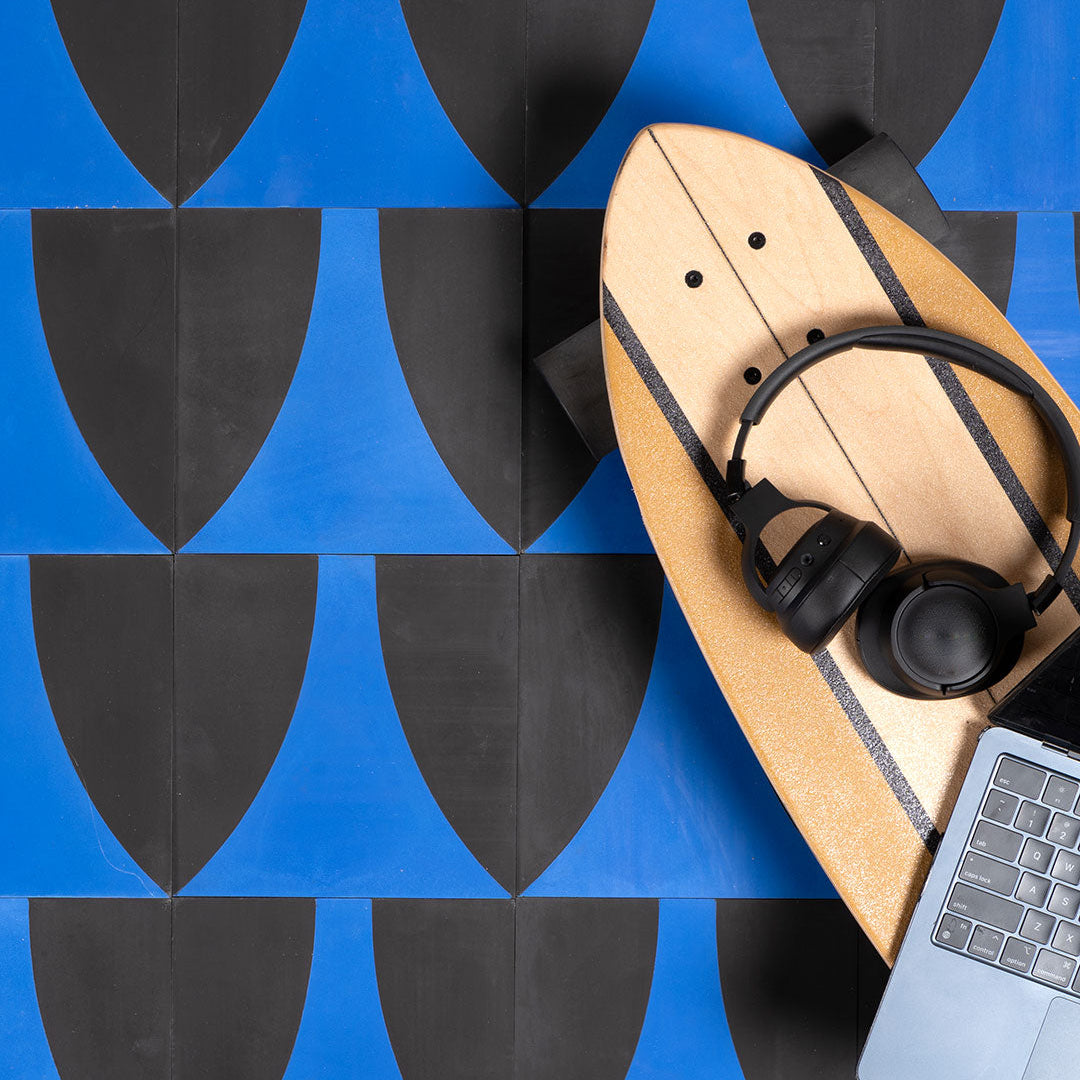 A bold geometric design with a curved cobalt blue shape against a charcoal black background, matte finish, ideal for modern or contemporary interior flooring and wall décor.