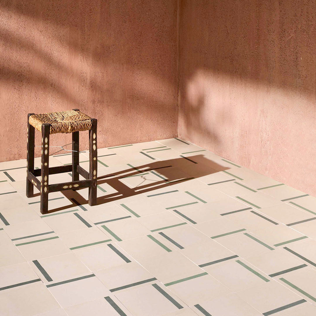 A decorative tile featuring a smooth soft beige background complemented by a bold green accent stripe, perfect for modern interior designs.