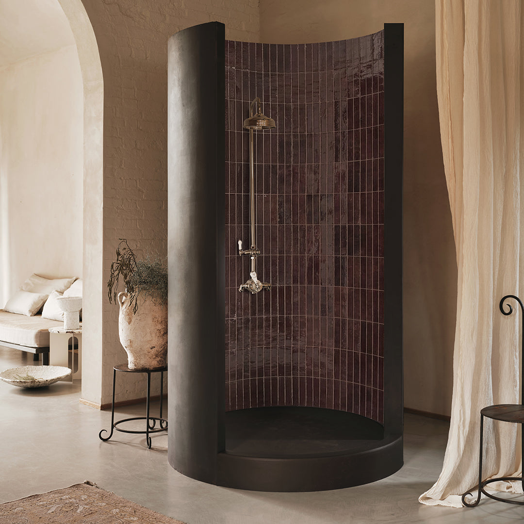 Modern shower enclosure with tiled wall in a bathroom setting