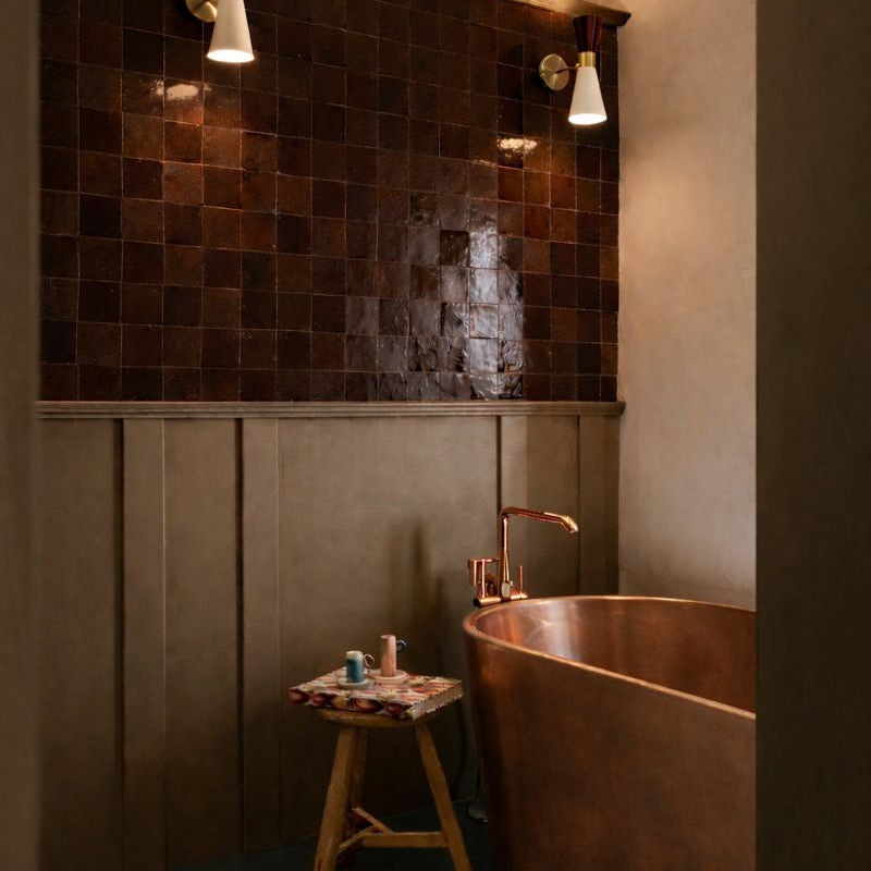 Bathroom with copper bathtub and tiled wall