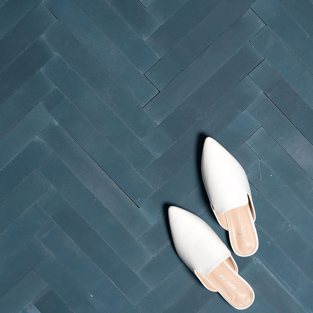 Cement tile featuring elongated rectangular strips in deep teal blue arranged in a herringbone pattern, matte finish, ideal for modern, coastal, or contemporary interior flooring and wall décor applications.