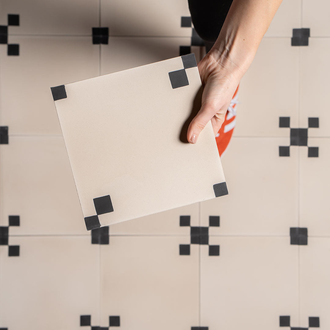 Minimalist floor tile featuring a cream base with four black corner squares, ideal for modern interiors, geometric wall patterns, or vintage-inspired flooring designs.
