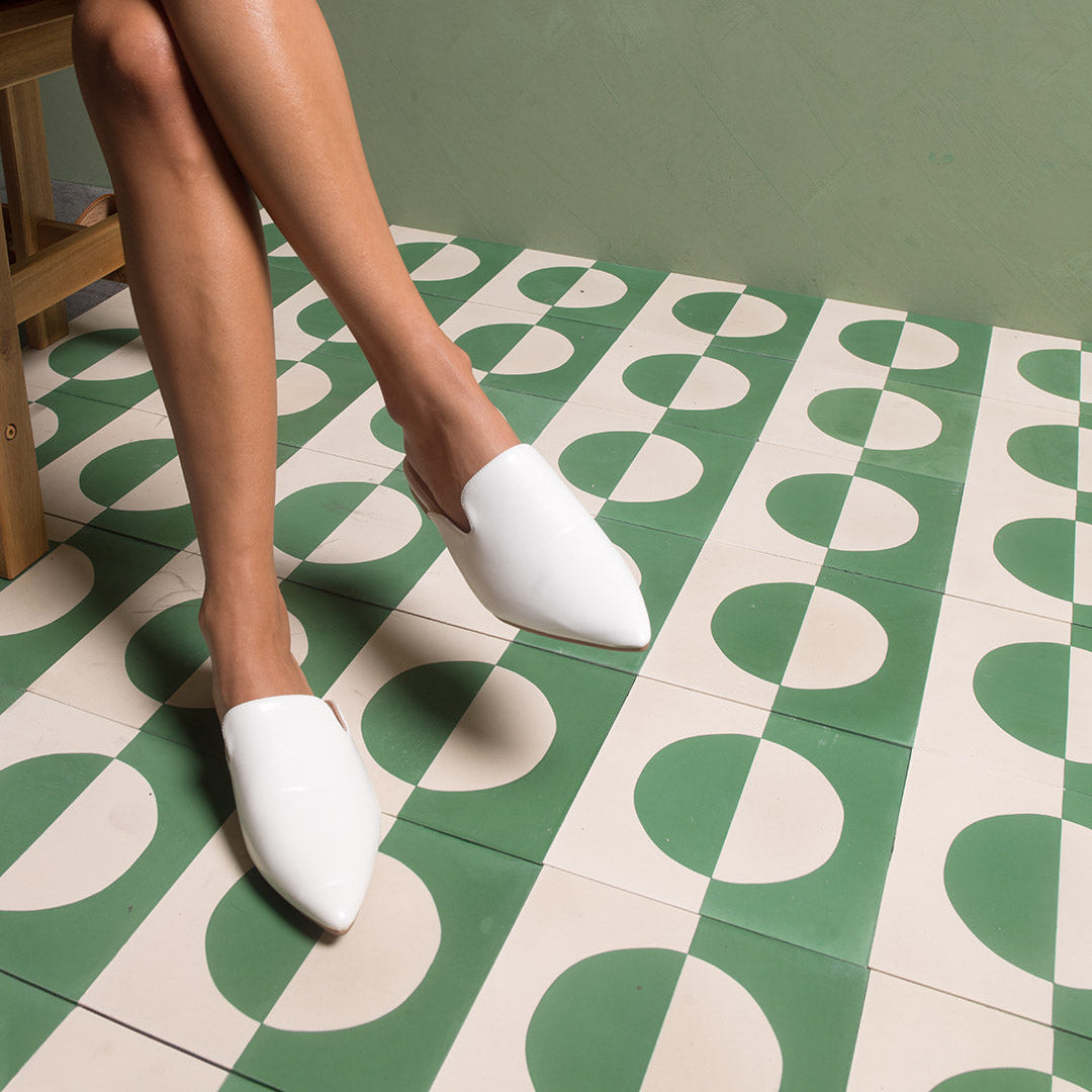 A geometric circle pattern in sage green and off-white, matte finish, ideal for modern, minimalist, or contemporary interior flooring and wall décor applications.