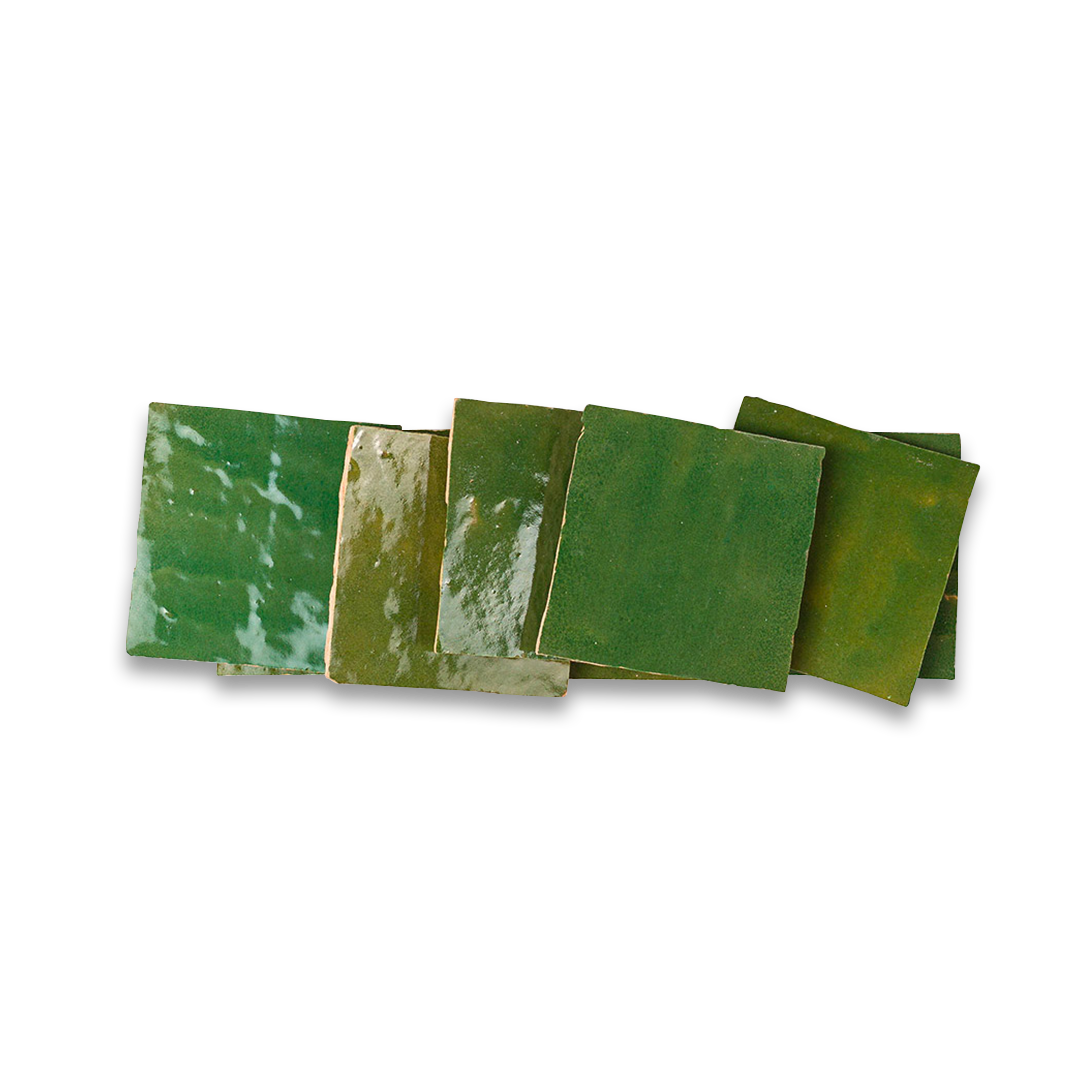 Green ceramic tiles with marbled patterns on a white background