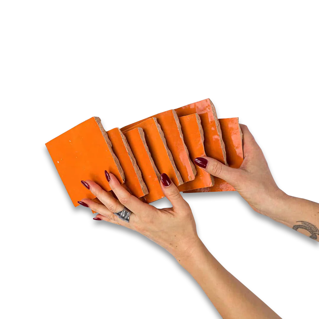 Orange sanding blocks held by hands on a white background