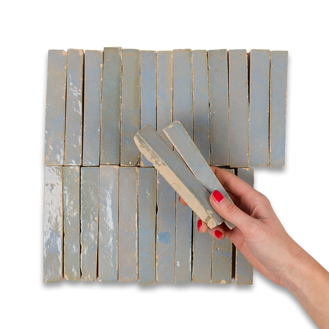 Hand holding a rectangular tool against a wooden panel with slats on a white background