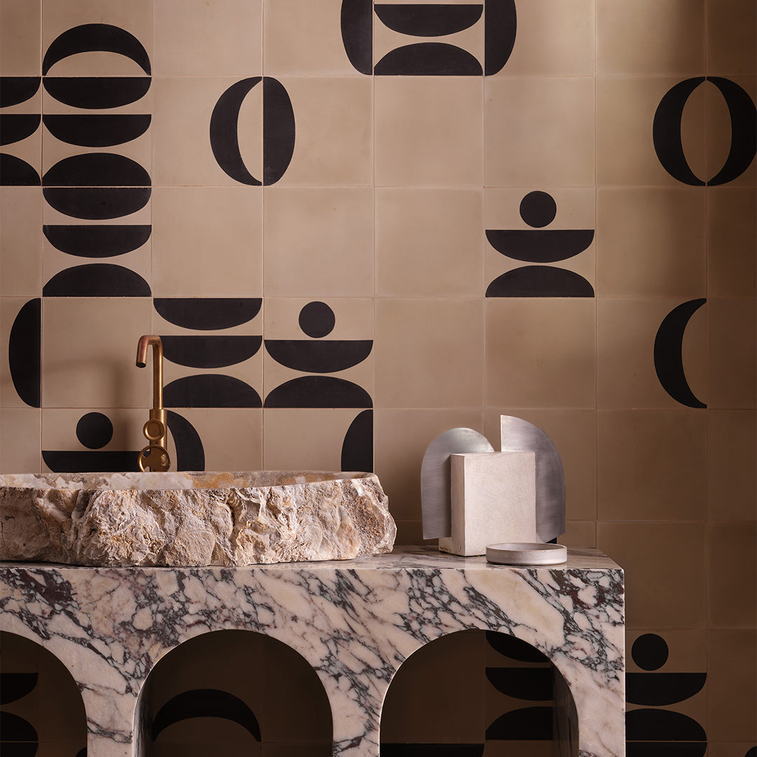 Beige and black geometric cement tile featuring bold curved and circular patterns, minimalist modern design, matte finish, ideal for contemporary flooring, wall décor, and architectural interior applications.