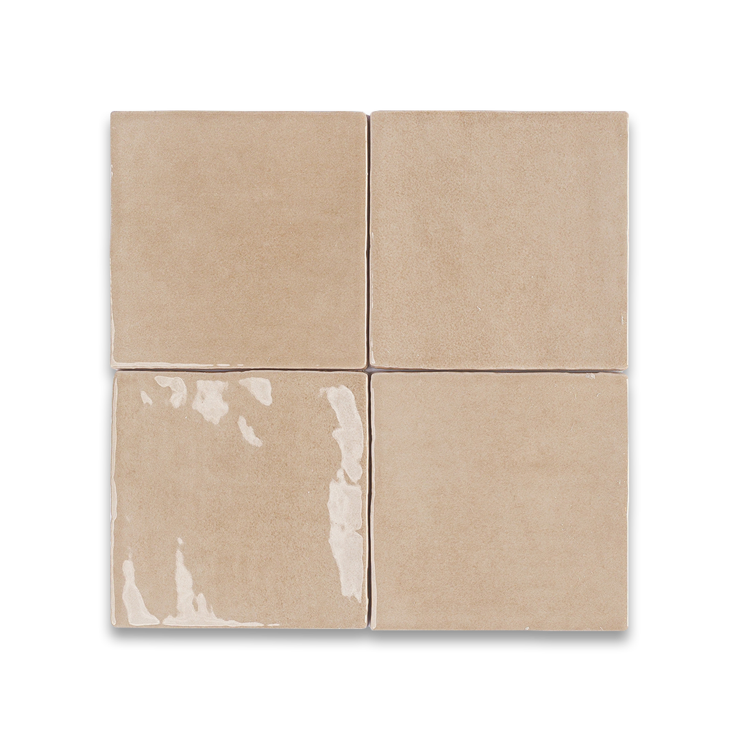 Beige ceramic tiles arranged in a grid pattern on a white background