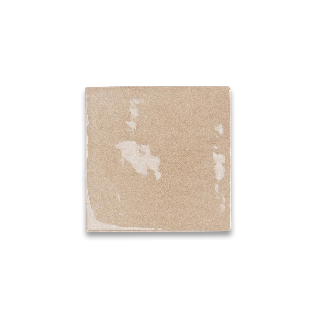 Beige blanket with white floral patterns on a white background