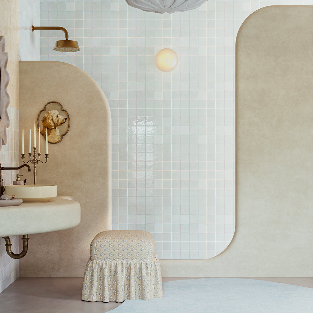 Bathroom interior with a sink, stool, and decorative elements.