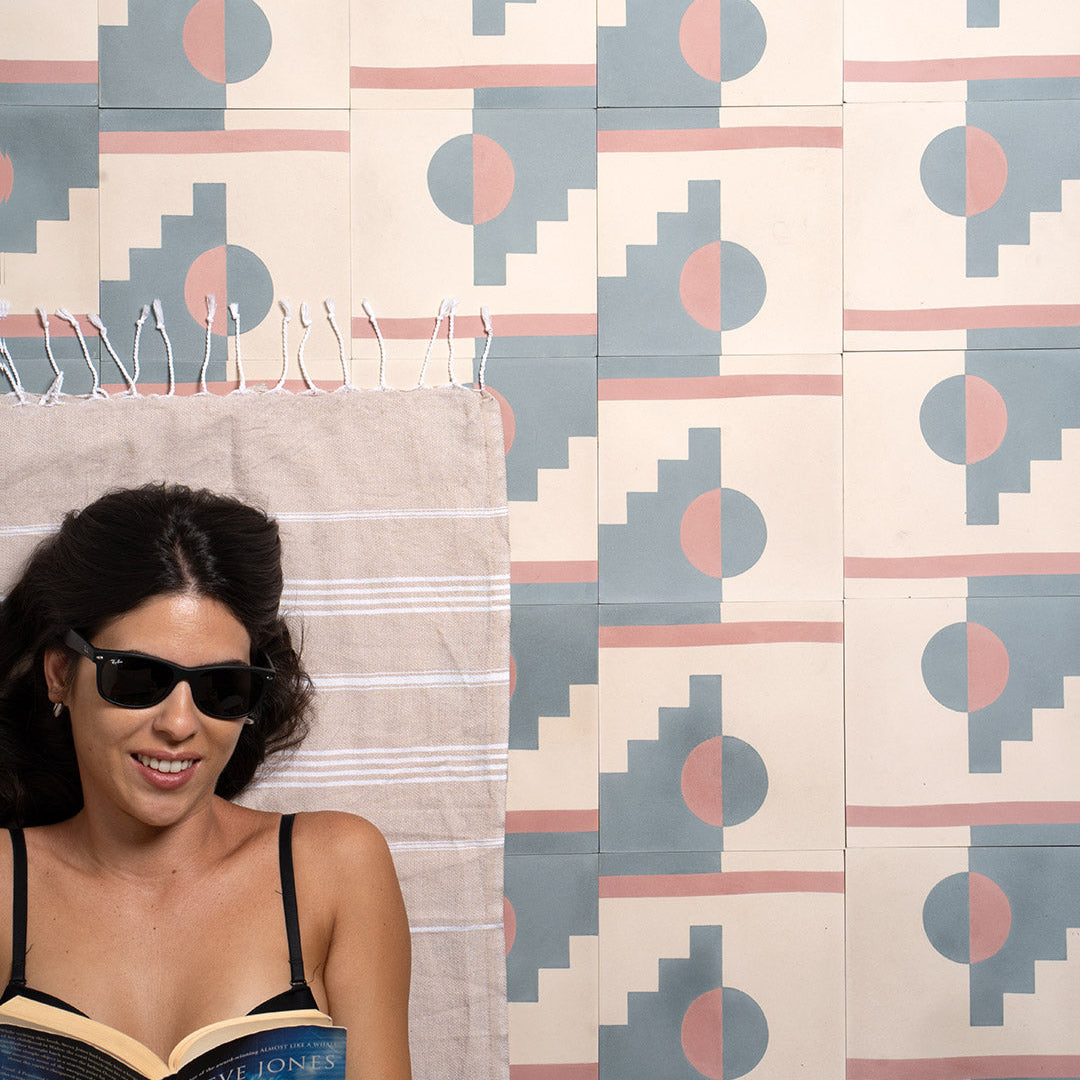 Pastel Eclipse cement tile featuring a geometric design with a half-circle sun, stepped blue pattern, and vertical pink stripe on a cream base, matte finish, ideal for modern, retro, or artistic interiors