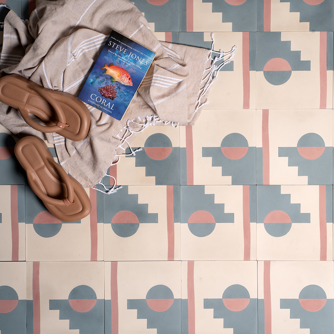 Pastel Eclipse cement tile featuring a geometric design with a half-circle sun, stepped blue pattern, and vertical pink stripe on a cream base, matte finish, ideal for modern, retro, or artistic interiors