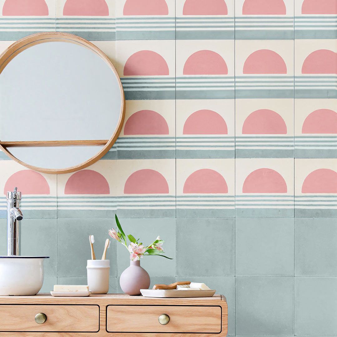 Sunset Stripes cement tile featuring a large pink semicircle sun above soft blue horizontal lines on a cream base, matte finish, ideal for coastal, bohemian, or modern interior wall and floor décor.