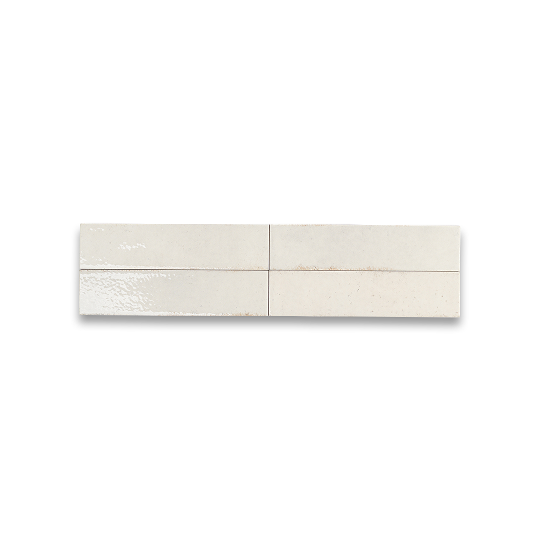 Rectangular light beige ceramic bathroom tiles with glossy finish and subtle speckled texture.