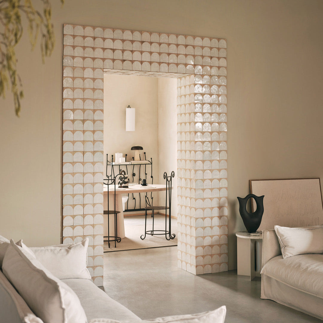 Decorative room divider with geometric pattern in a living room setting