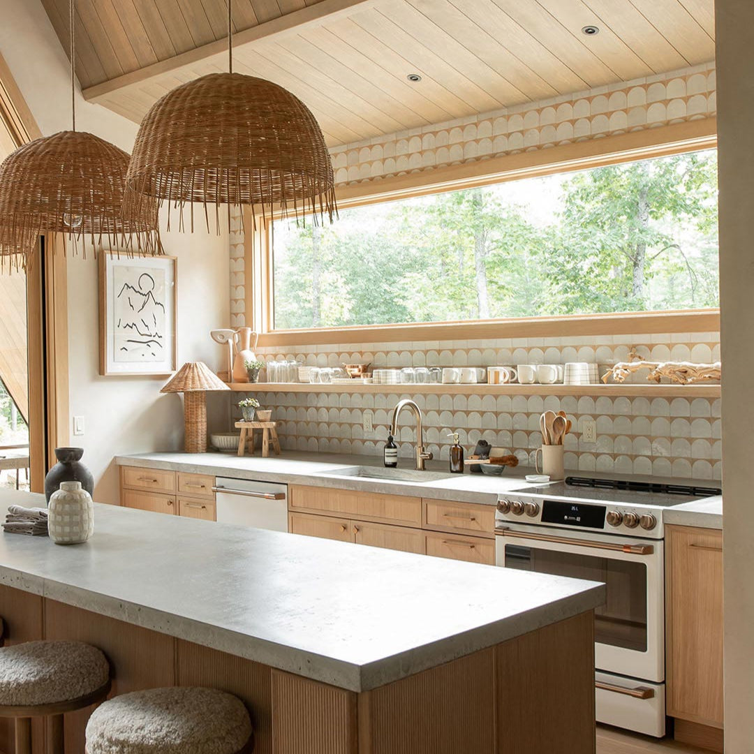 Modern kitchen with wooden cabinets, white countertops, and a large window.