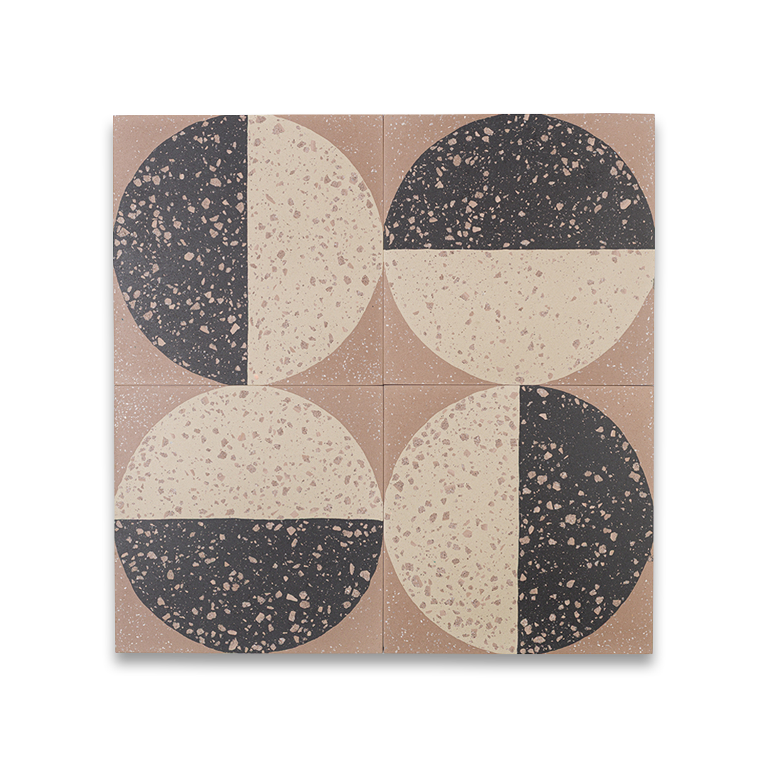 A square cement tile featuring a large circle divided into black and beige halves with terrazzo speckles, set against a warm brown background for a modern geometric look.
