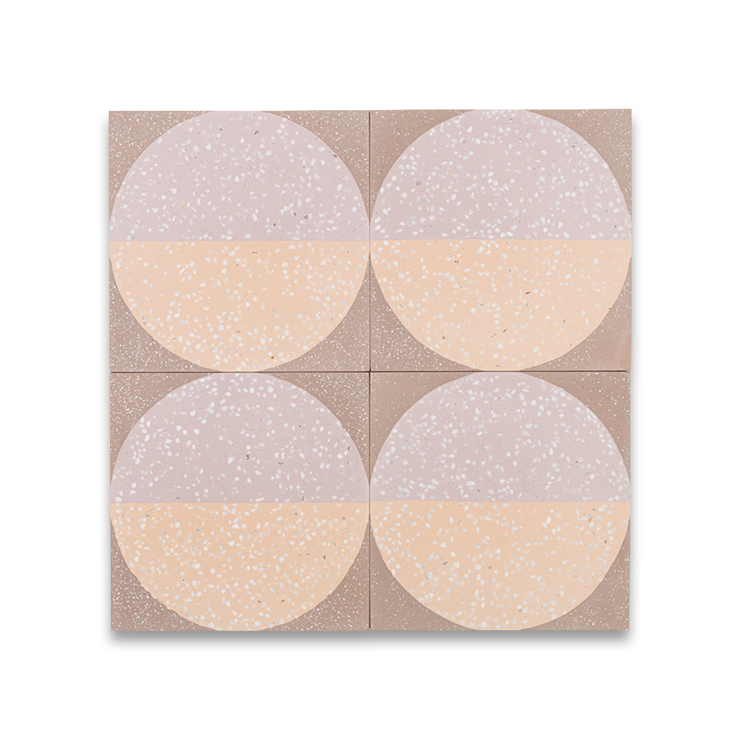 A square cement tile featuring a large circle divided into peach and mauve halves with white terrazzo speckles, set against a taupe background for a modern geometric look.