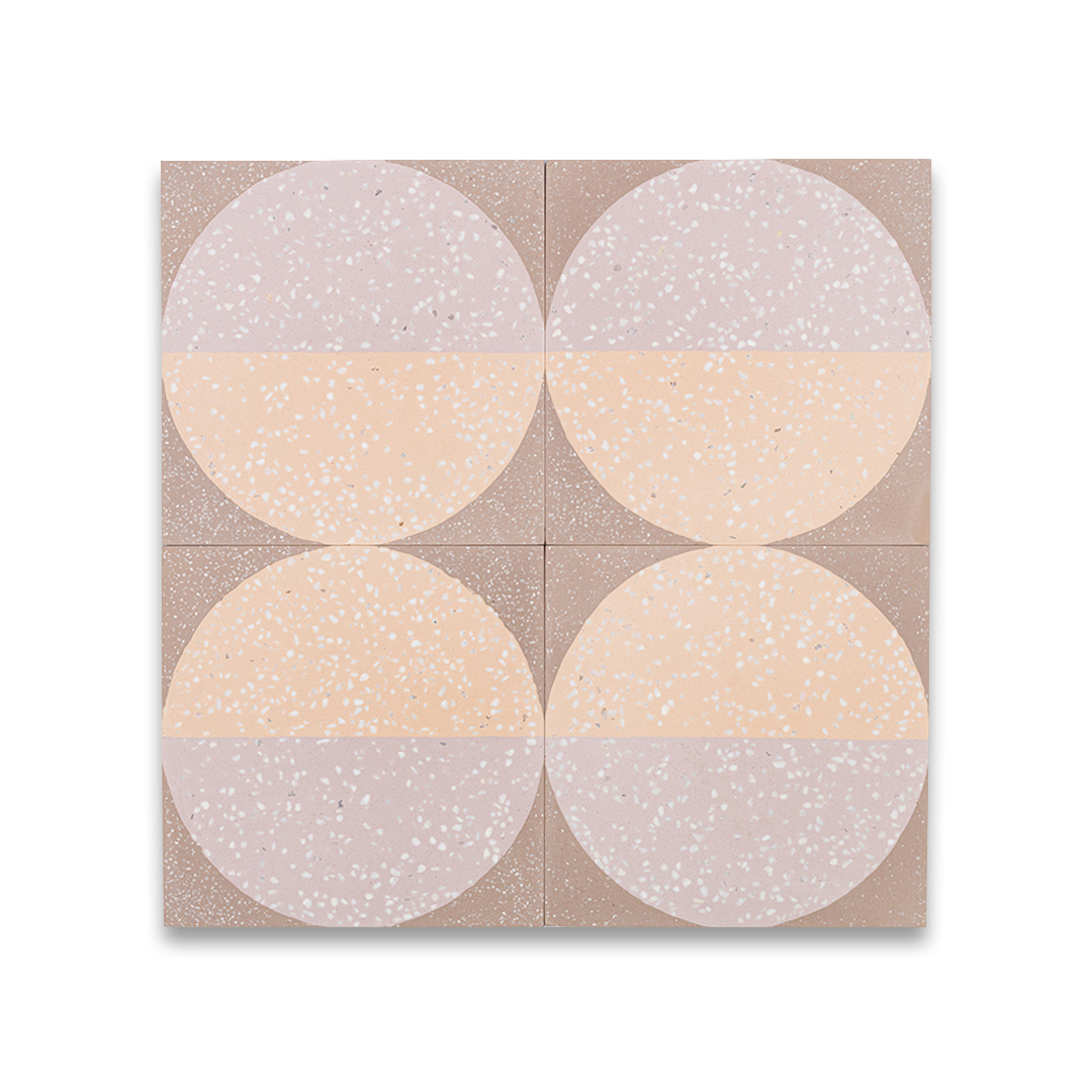A square cement tile featuring a large circle divided into peach and mauve halves with white terrazzo speckles, set against a taupe background for a modern geometric look.